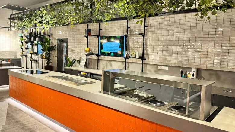 Finished orange tiled food counter with heated display unit at Wellington College