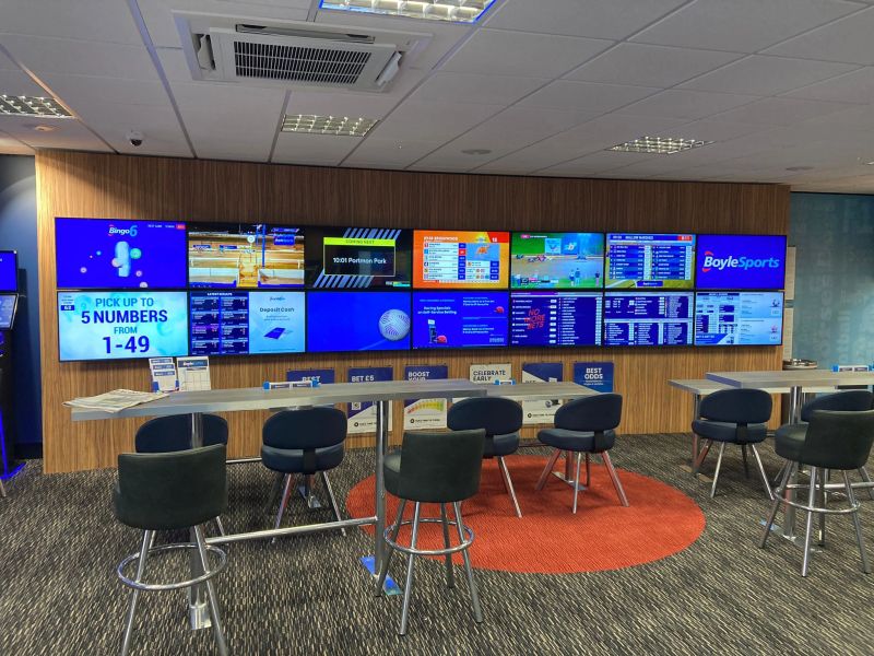 BoyleSports Banbury interior fit-out with branded blue gantry wall
