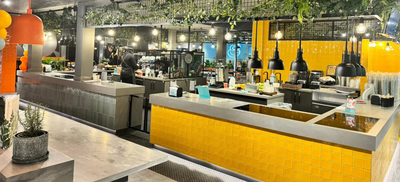 Finished servery at Wellington College with yellow tiled counters and stainless steel worktops