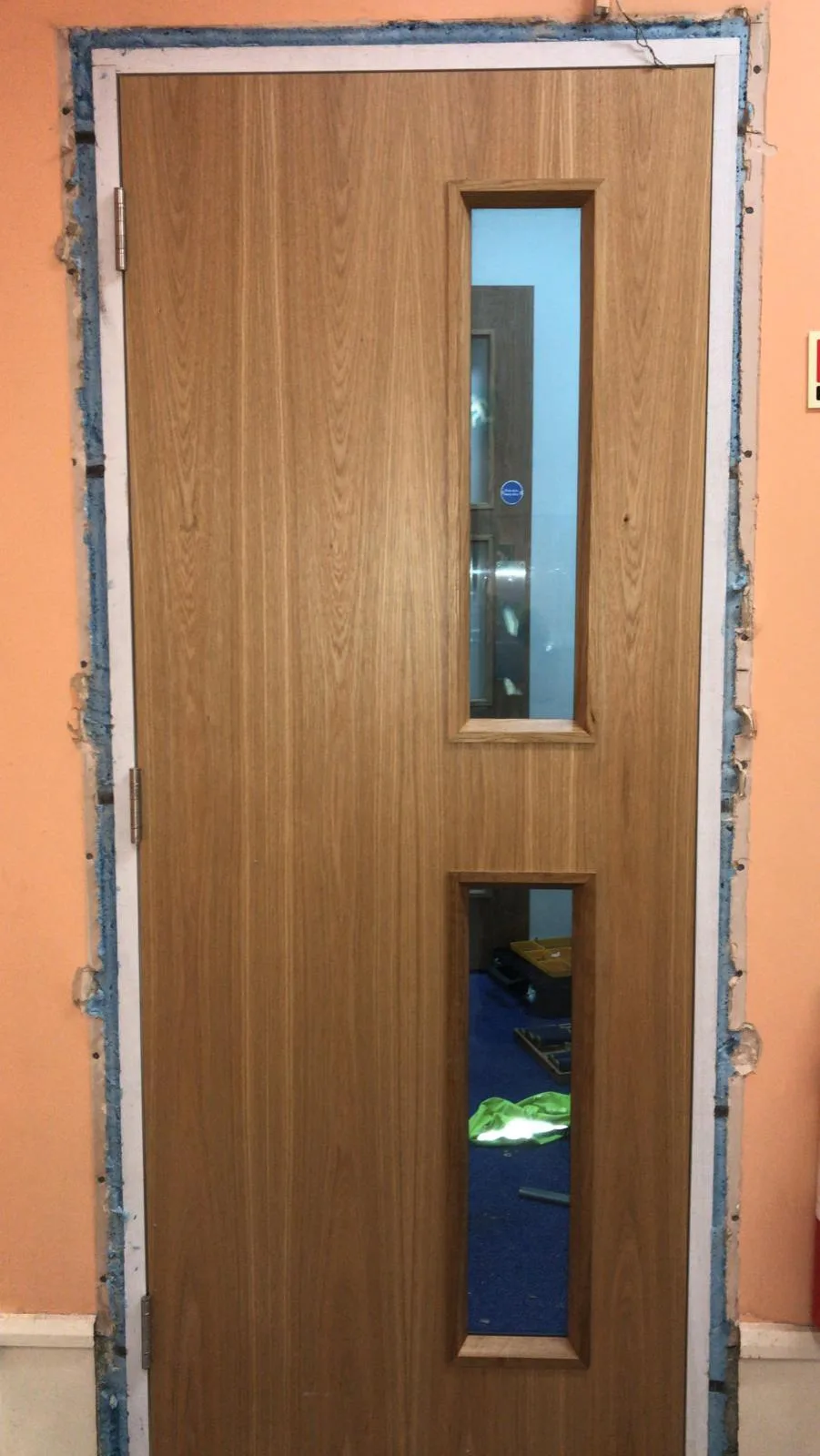 Single fire door during installation at Redtape Studios, Sheffield