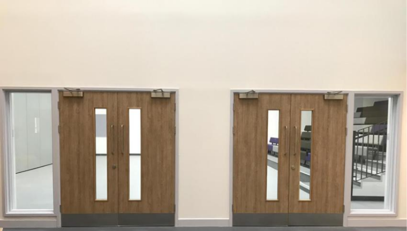 Double fire door sets with glazed panels demonstrating school safety standards